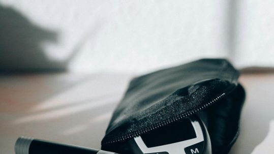 What we cover in each Diabetes Reset session: a black‑and‑white diabetes test kit featuring a glucose meter, lancet device, and test strips on a sunlit table.