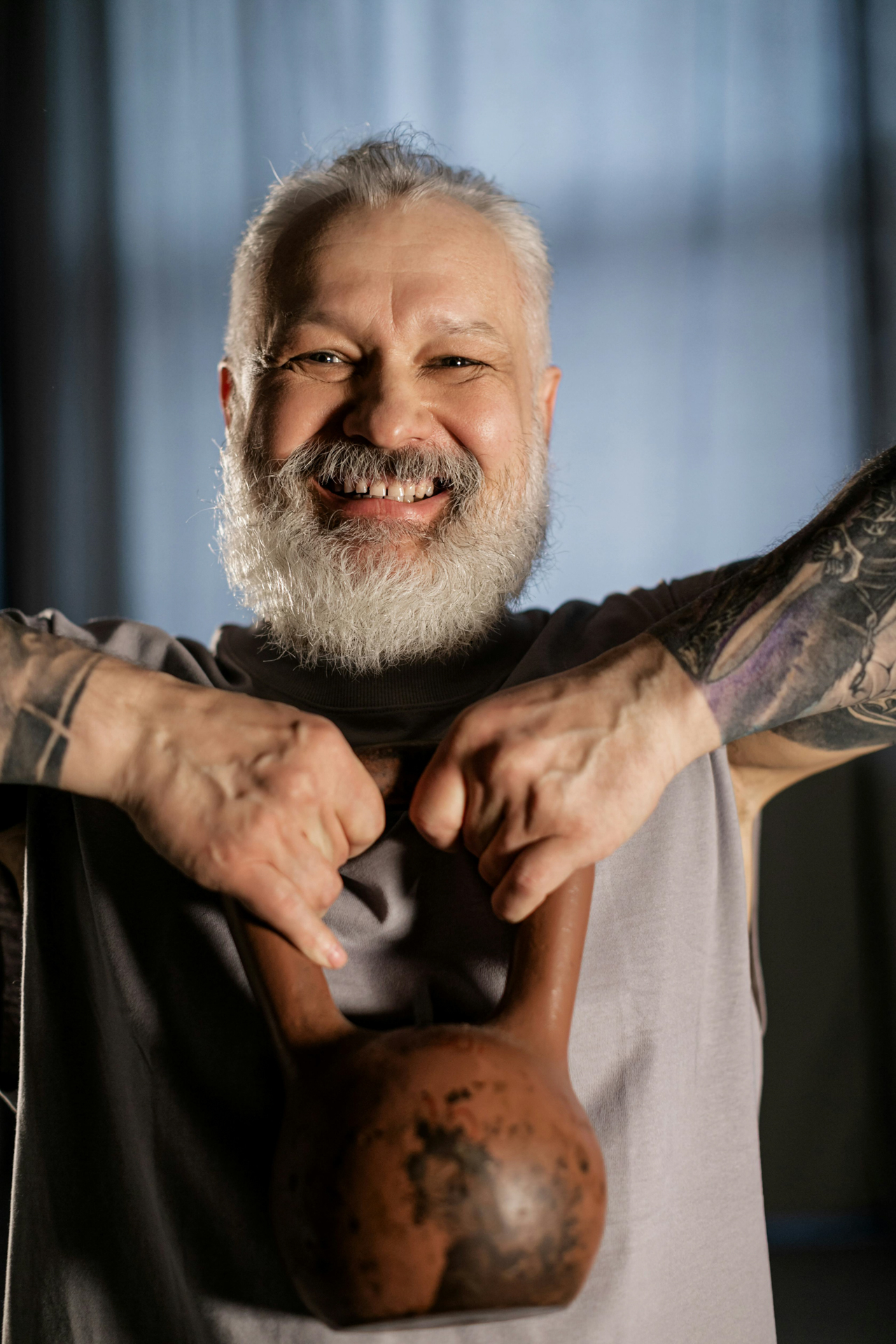 kettlebell high hold smiling man. what we cover in each Total Transformation session